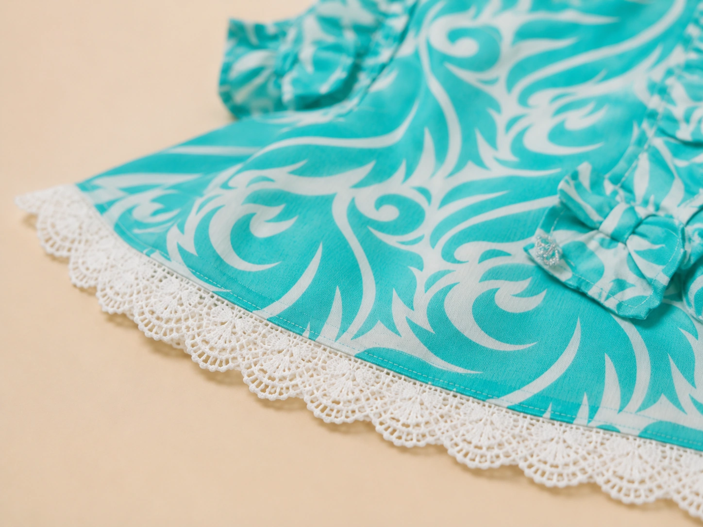 Close-up of ruffle-and-bow sleeve and white lace