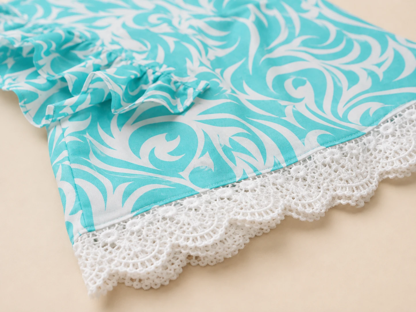 Close-up of white crochet lace and swirl print