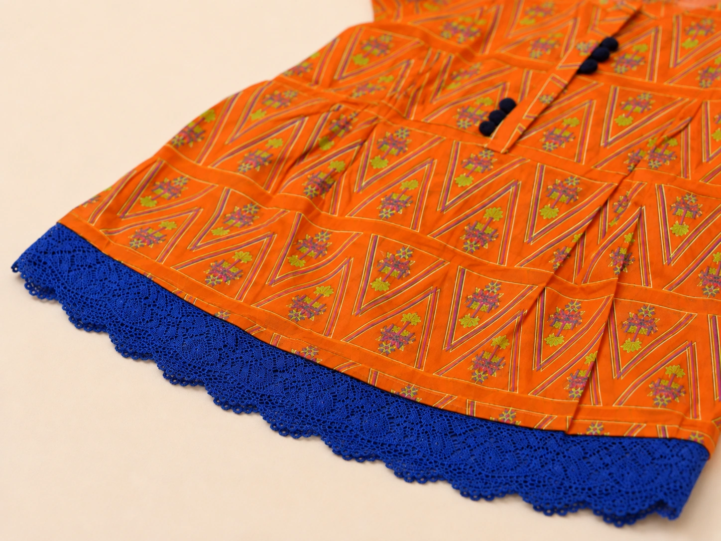 Close-up of navy tassel placket and blue lace