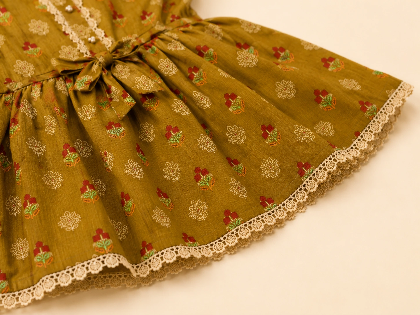 Close-up of tie waist and cream lace