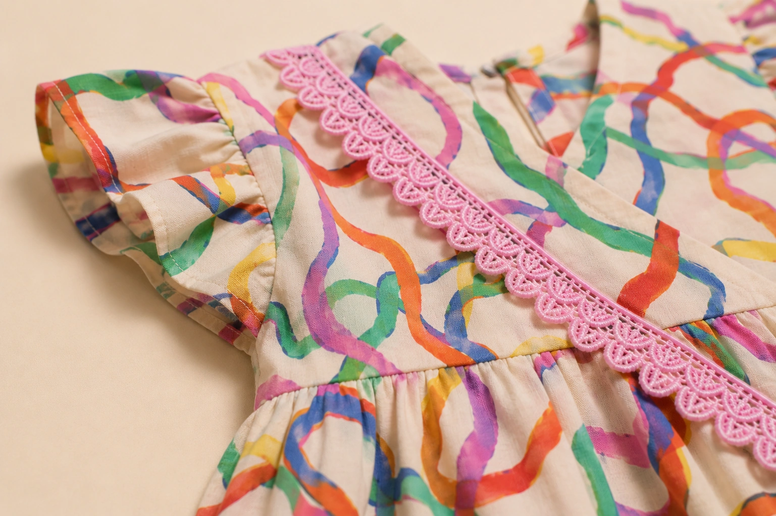 Close-up of pink scalloped lace and ribbon print